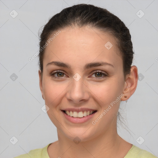 Joyful white young-adult female with short  brown hair and brown eyes