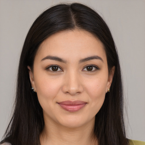 Joyful latino young-adult female with long  brown hair and brown eyes