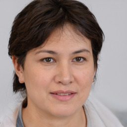 Joyful white adult female with medium  brown hair and brown eyes