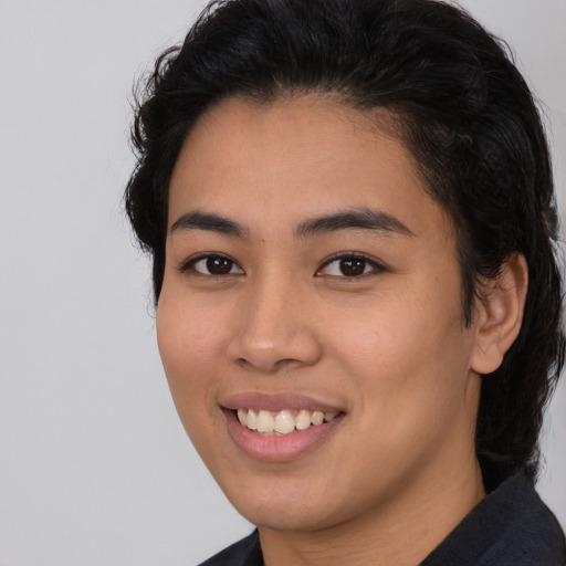 Joyful latino young-adult female with medium  brown hair and brown eyes