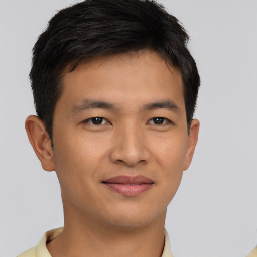 Joyful asian young-adult male with short  brown hair and brown eyes