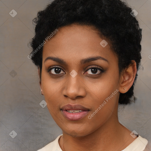 Joyful black young-adult female with short  black hair and brown eyes