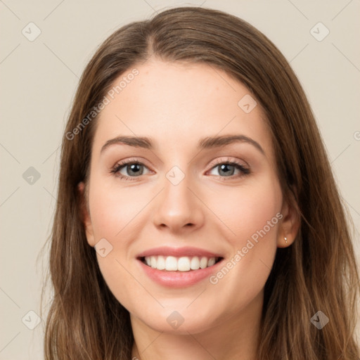 Joyful white young-adult female with long  brown hair and green eyes