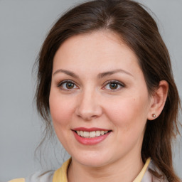 Joyful white young-adult female with medium  brown hair and brown eyes