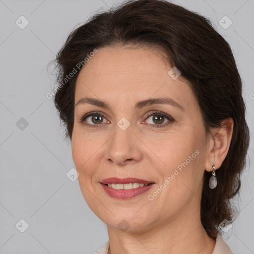 Joyful white adult female with medium  brown hair and brown eyes