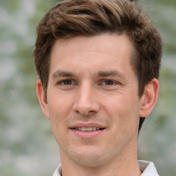 Joyful white young-adult male with short  brown hair and grey eyes