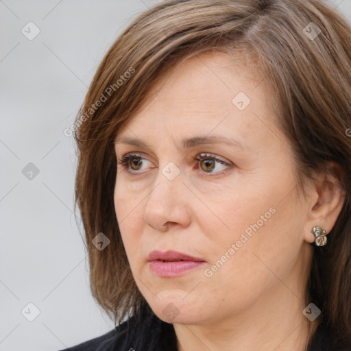 Joyful white adult female with long  brown hair and blue eyes