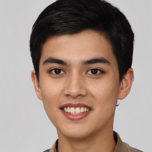 Joyful latino young-adult male with short  black hair and brown eyes