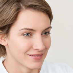 Joyful white young-adult female with medium  brown hair and blue eyes