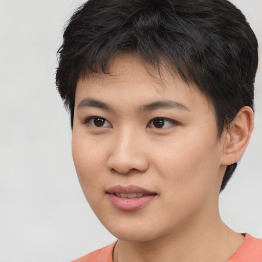 Joyful asian young-adult female with short  brown hair and brown eyes