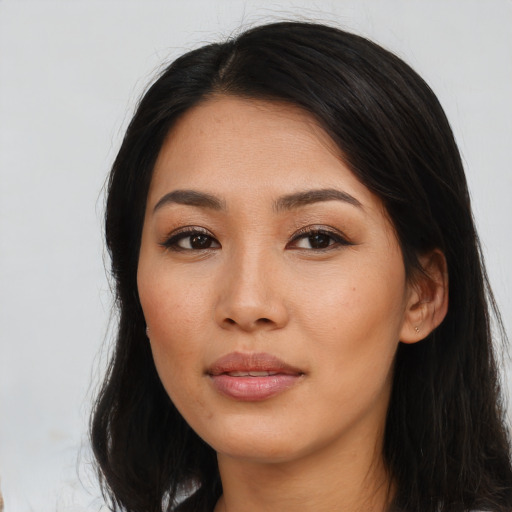 Joyful latino young-adult female with long  black hair and brown eyes