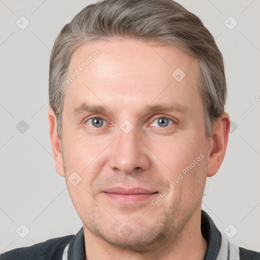 Joyful white adult male with short  brown hair and grey eyes