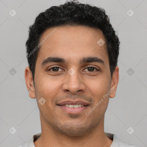 Joyful latino young-adult male with short  black hair and brown eyes