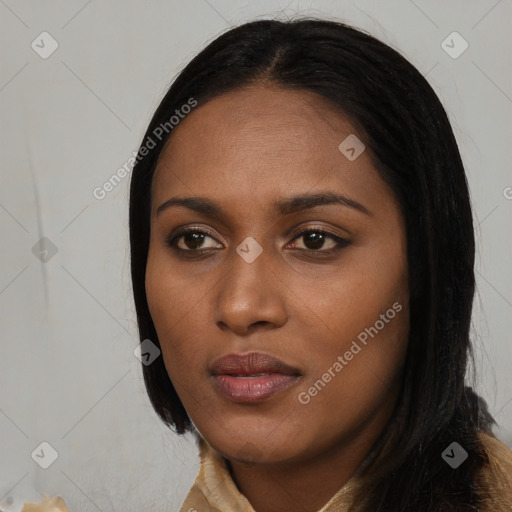 Joyful black young-adult female with long  black hair and brown eyes