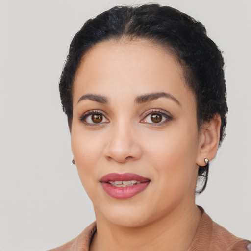 Joyful latino young-adult female with short  black hair and brown eyes