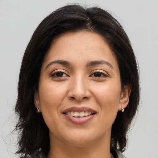 Joyful asian young-adult female with long  brown hair and brown eyes