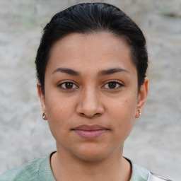 Joyful latino young-adult female with short  brown hair and brown eyes