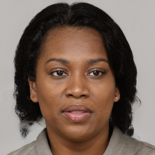 Joyful black young-adult female with medium  black hair and brown eyes