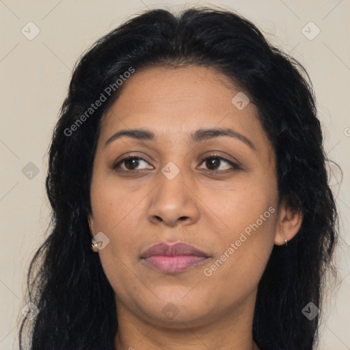 Joyful latino adult female with long  brown hair and brown eyes
