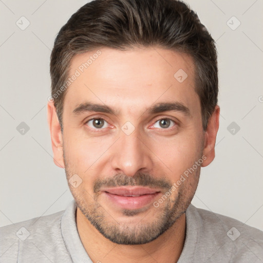 Joyful white young-adult male with short  brown hair and brown eyes