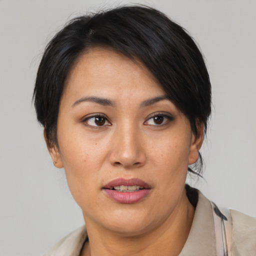 Joyful asian young-adult female with short  black hair and brown eyes