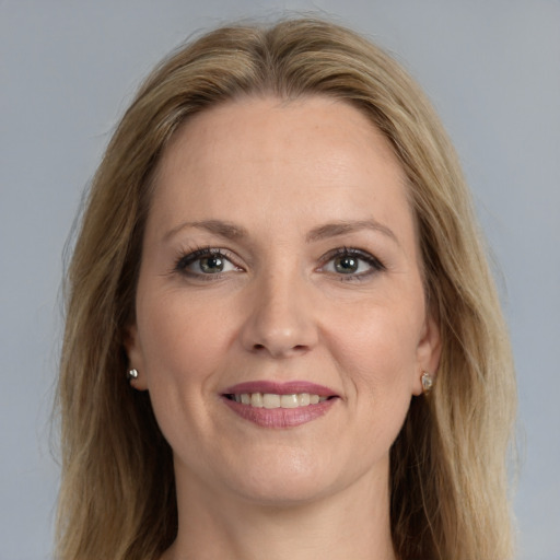 Joyful white adult female with long  brown hair and grey eyes