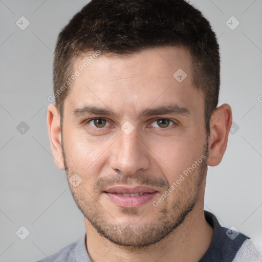 Joyful white young-adult male with short  brown hair and brown eyes