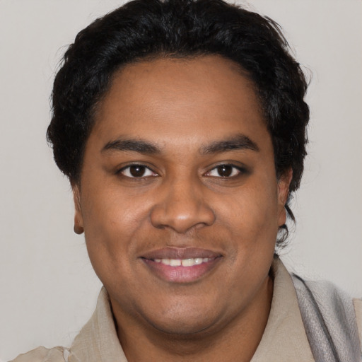 Joyful black young-adult male with short  black hair and brown eyes