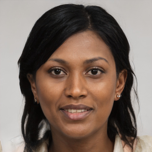 Joyful black young-adult female with medium  black hair and brown eyes