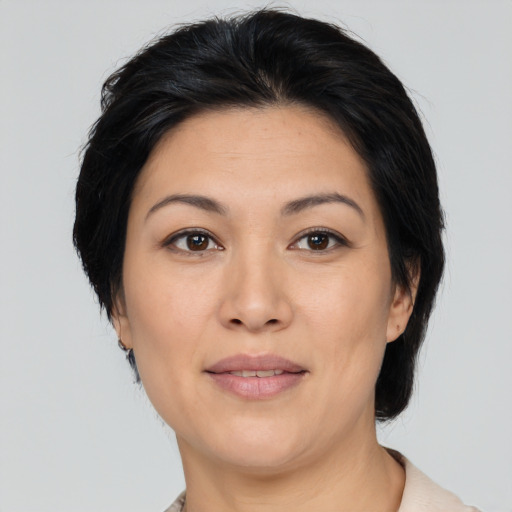 Joyful asian adult female with medium  black hair and brown eyes