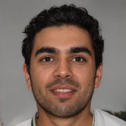 Joyful white young-adult male with short  black hair and brown eyes
