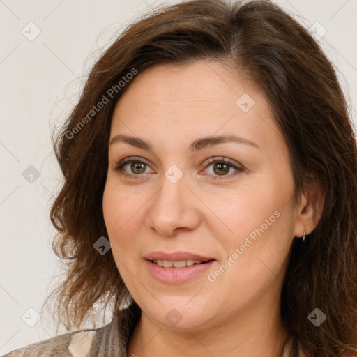 Joyful white adult female with long  brown hair and brown eyes