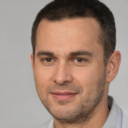 Joyful white adult male with short  brown hair and brown eyes