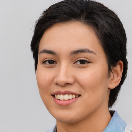 Joyful asian young-adult female with short  brown hair and brown eyes