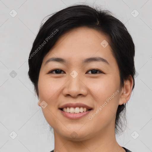 Joyful asian young-adult female with medium  black hair and brown eyes