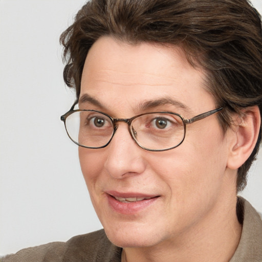 Joyful white adult male with medium  brown hair and grey eyes