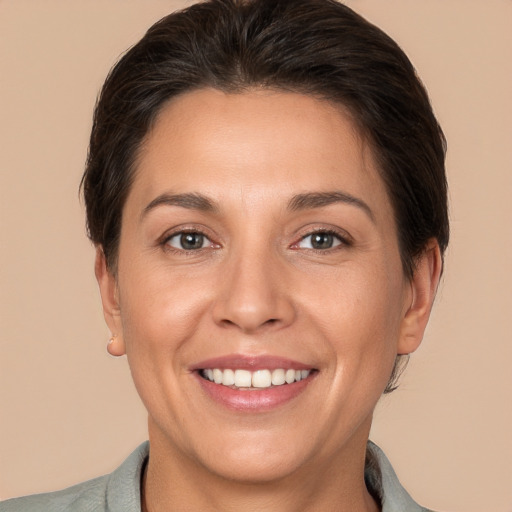 Joyful white adult female with short  brown hair and brown eyes