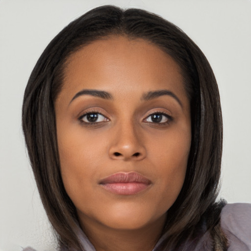 Joyful latino young-adult female with long  brown hair and brown eyes