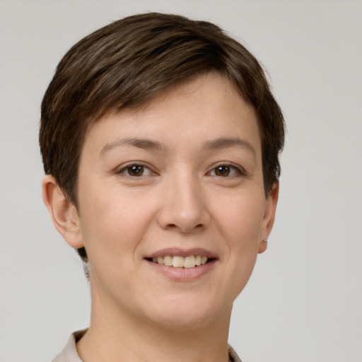Joyful white young-adult female with short  brown hair and grey eyes