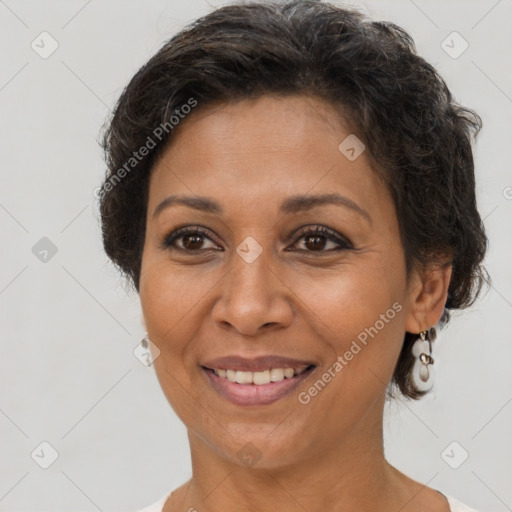 Joyful latino adult female with short  brown hair and brown eyes