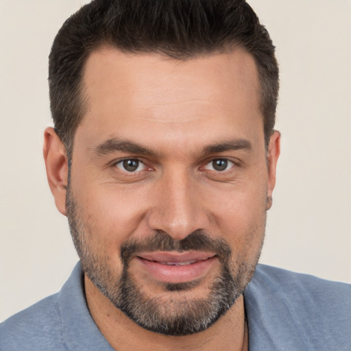 Joyful white adult male with short  brown hair and brown eyes