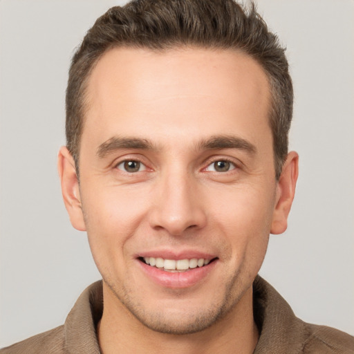 Joyful white young-adult male with short  brown hair and brown eyes