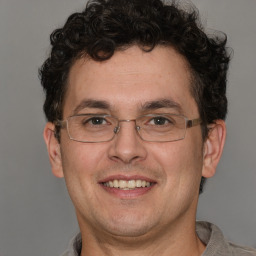 Joyful white adult male with short  brown hair and brown eyes