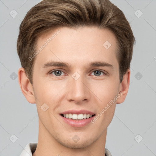 Joyful white young-adult male with short  brown hair and grey eyes