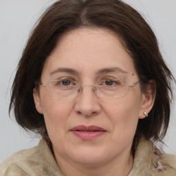 Joyful white adult female with medium  brown hair and grey eyes