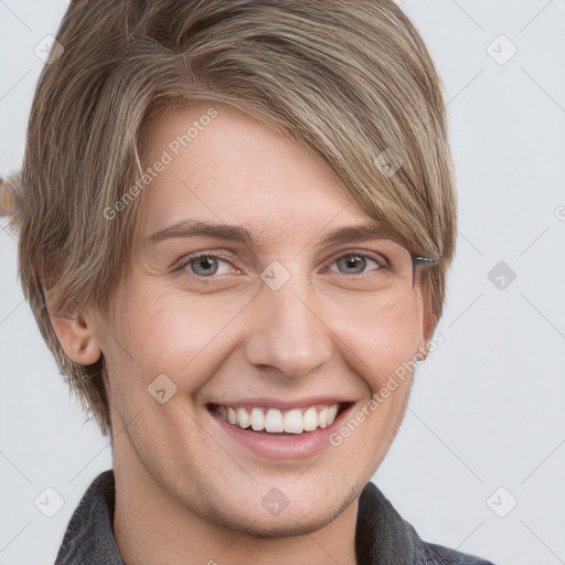 Joyful white young-adult female with short  brown hair and blue eyes