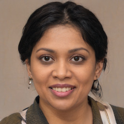 Joyful black young-adult female with medium  brown hair and brown eyes