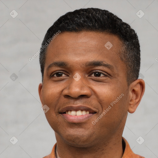 Joyful black young-adult male with short  black hair and brown eyes