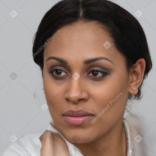 Joyful latino young-adult female with medium  brown hair and brown eyes