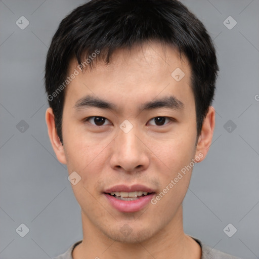 Joyful asian young-adult male with short  brown hair and brown eyes